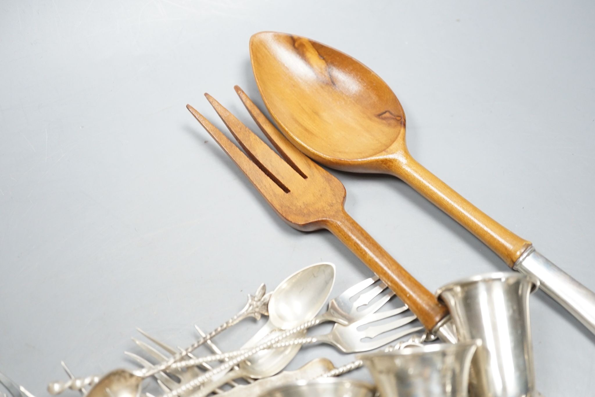 A quantity of American sterling items including four beakers, twelve assorted small goblets(weighted?), six assorted condiments(weighted?) and group of miscellaneous flatware